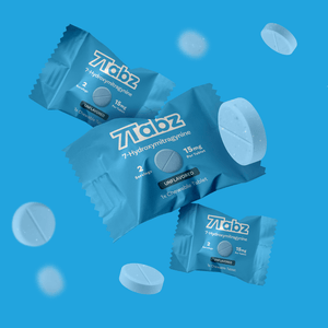 Blue wrapped Ztabz tablets or mints with floating white circular pills.