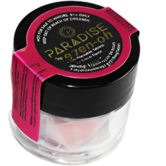 Clear jar with a black lid and pink label containing Paradise Makeup.