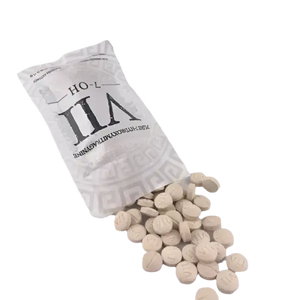 White tablets or pills spilling from a silver-gray packet labeled ’ILA’.